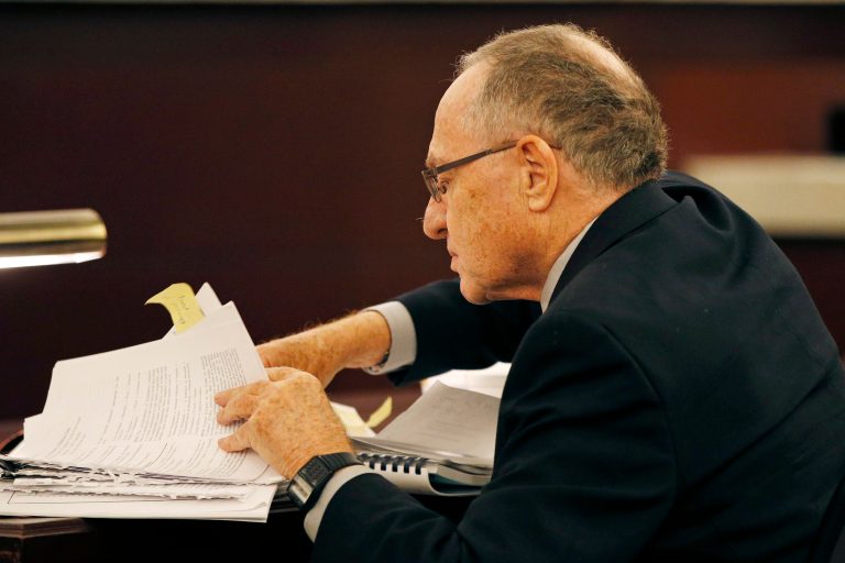 Attorney Alan Dershowitz looks through papers during a session of the Nevada Supreme Court, Tuesday, April 5, 2016, in Las Vegas. The Nevada Supreme Court heard arguments in casino mogul Sheldon Adelson's effort to disqualify a judge in a civil wrongful termination lawsuit involving a former Sands China executive.
