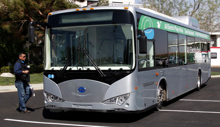 FILE - In this May 1, 2013, file photo, an electric bus produced by China's BYD Co., is parked at the announcement of the opening of an electric bus manufacturing plant in Lancaster, Calif. The Chinese automaker that sold more electric cars last year than Tesla, Nissan and GM combined is taking a back road into the American market on a battery-powered bus.
