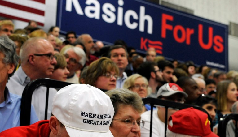 A supporter for Donald Trump sits in the front row of the bleachers at a campaign event for Republican presidential candidate Ohio Gov. John Kasich, Friday, April 22, 2016, in Glastonbury, Conn.