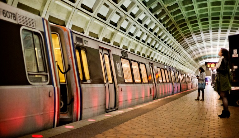 Passengers wait on the platform before boarding a train at a Metro Station in Washington.