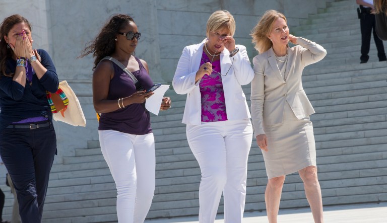 Amy Hagstrom Miller, second from right, founder of Whole Woman's Health, a Texas women's health clinic that provides abortions, leaves the Supreme Court in Washington, Monday, June 27, 2016, with Center for Reproductive Rights President Nancy Northup, far right, as the justices struck down the strict Texas anti-abortion restriction law known as HB2. The justices voted 5-3 in favor of Texas clinics that had argued the regulations were a thinly veiled attempt to make it harder for women to get an abortion in the nation's second-most populous state. The case is Whole Woman's Health v. Hellerstedt. 