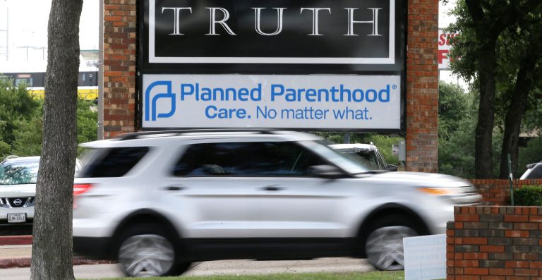 In this Monday, June 27, 2016 photo, traffic passes a Planned Parenthood sign in Dallas. 
