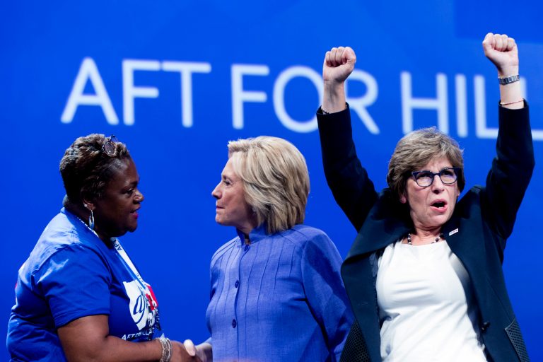 Democratic presidential candidate Hillary Clinton, center, greets a supporter on stage with AFT President Randi Weingarten, right, after speaking at the American Federation of Teachers convention at the Minneapolis Convention Center in Minneapolis, Monday, July 18, 2016.