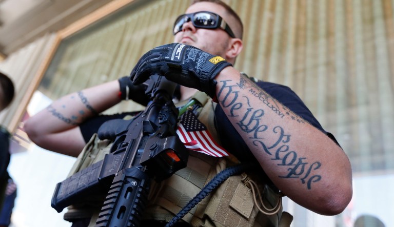 Tevor Leis, exercising his Ohio open carry rights, stands armed in Public Square on Tuesday, July 19, 2016, in Cleveland, during the second day of the Republican convention. 