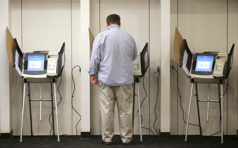 In this Nov. 3, 2015, file photo, a person votes, in Salt Lake City.