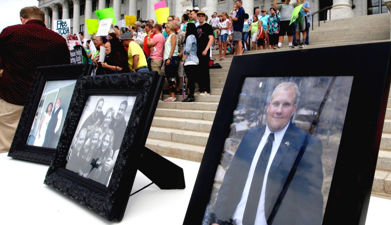 Family photographs of Josh Holt, an American jailed in Venezuela, are shown during a rally at the Utah State Capitol on July 30, 2016, in Salt Lake City. Holt was arrested on suspicion of weapons charges after he traveled to Venezuela on a tourist visa to marry a fellow Mormon he met on the internet.