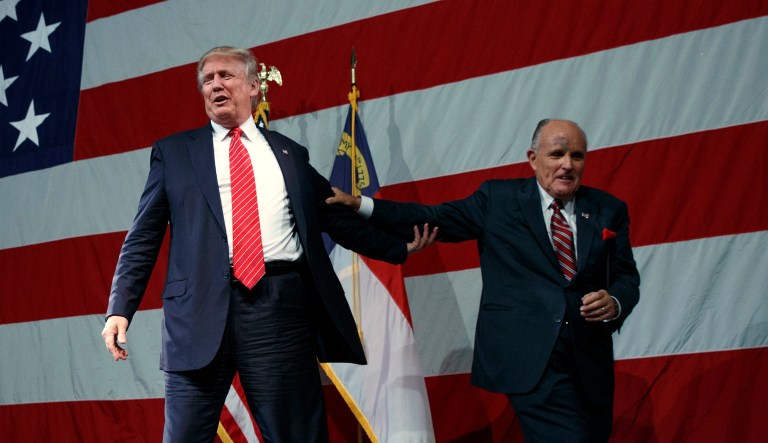 Republican presidential candidate Donald Trump, left, arrives after being introduced by former New York Mayor Rudy Giuliani during a campaign rally at Crown Arena, Tuesday, Aug. 9, 2016, in Fayetteville, N.C. 