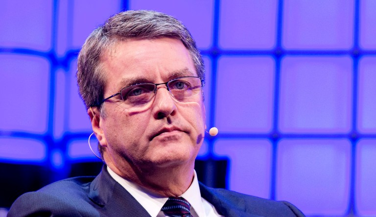 World Trade Organization chief Roberto Azevedo looks on while speaking at a conference.