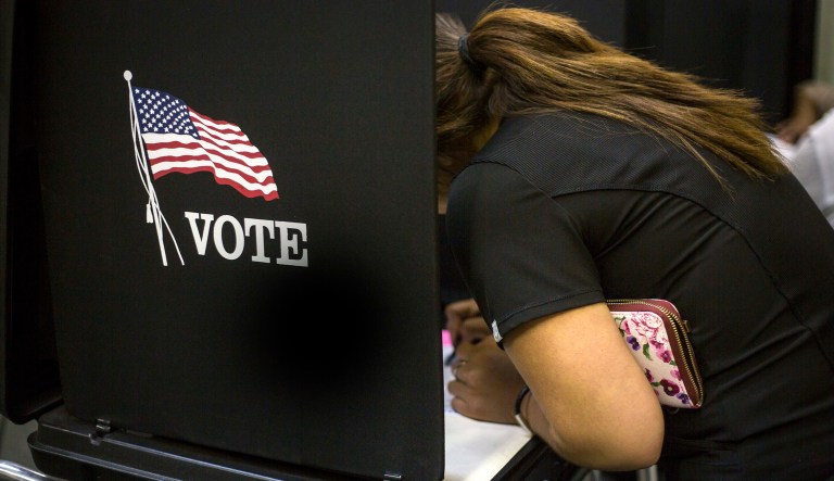 A voter casts her ballot at a polling station in Albuquerque, N.M.