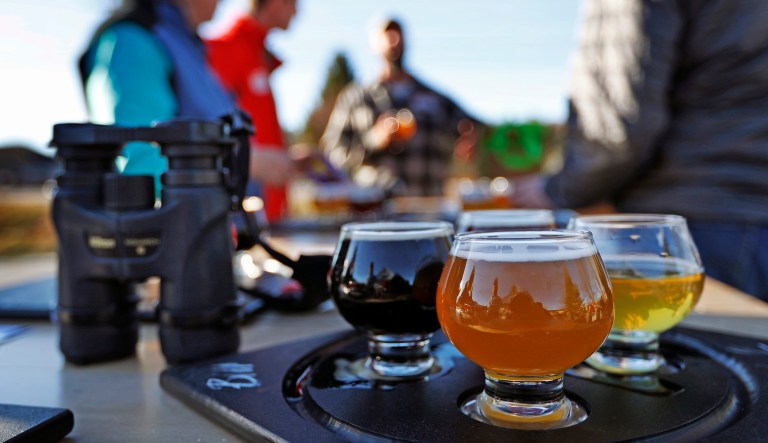 A group samples a flight of beers at the Maine Brewing Company in Freeport, Maine.