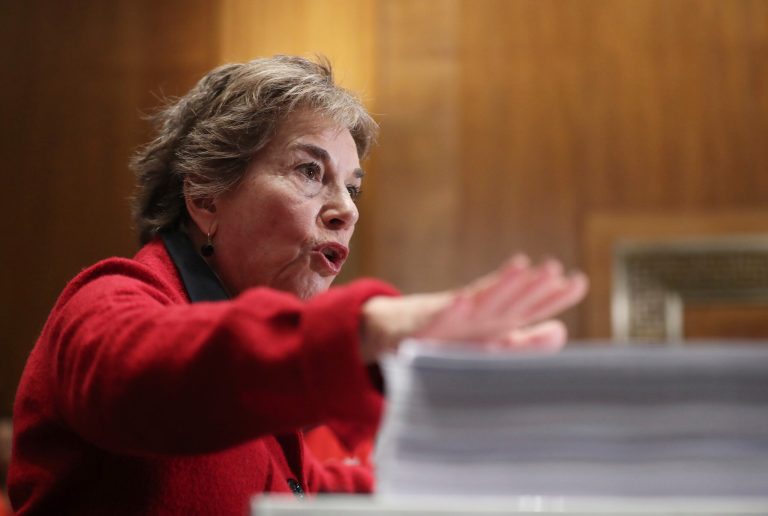 Rep. Jan Schakowsky, D-Ill., taps on several documents during a news conference on Capitol Hill in Washington.