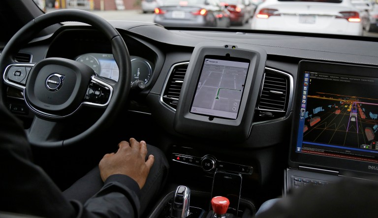 In this photo taken Tuesday, Dec. 13, 2016, an Uber driverless car waits in traffic during a test drive in San Francisco.