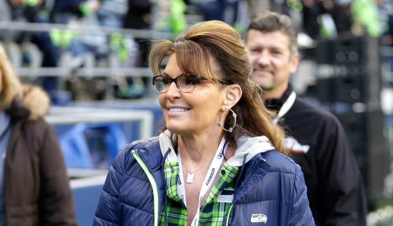 In this 2016 photo, Sarah Palin, political commentator and former governor of Alaska, walks on the sideline before an NFL football game between the Seattle Seahawks and the Los Angeles Rams.