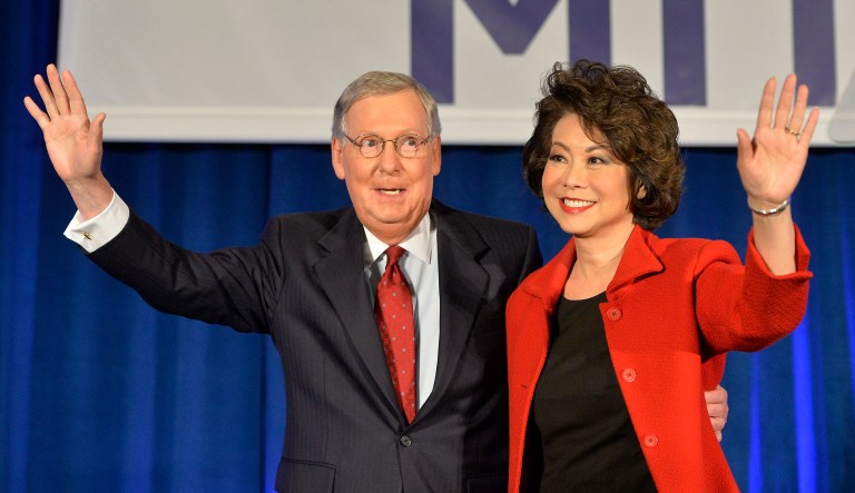 Senate Minority Leader Mitch McConnell of Kentucky and his wife, Elaine Chao, wave to a gathering of supporters.