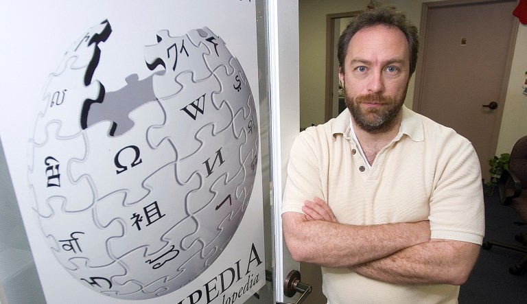 Wikipedia founder Jimmy Wales stands in the doorway to his office.