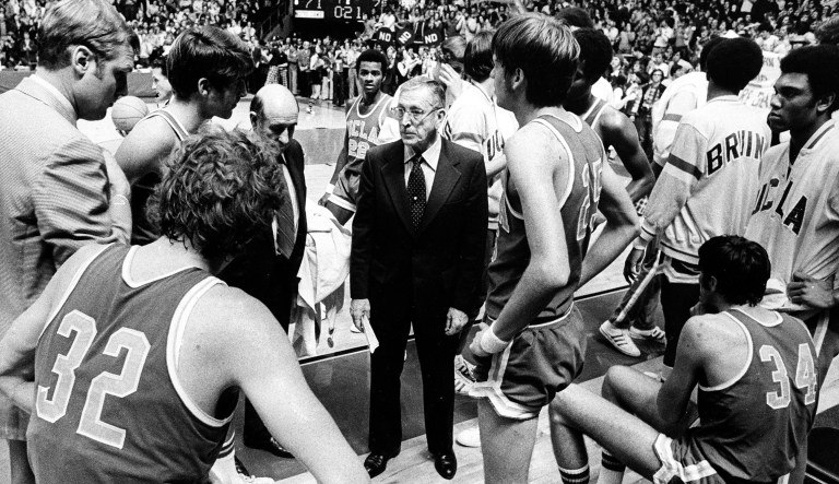 FILE - In this this Jan. 19, 1974 file photo, UCLA basketball coach John Wooden, center, talks to his team during the last time out against Notre Dame, in South Bend, Ind. At left foreground is Bill Walton (32). The date the streak ended is burned in Walton's memory. He spits it out with distaste when asked what he recalls most about UCLA's NCAA-record 88-game winning streak. UConn's women's basketball team is on the verge of winning its 91st straight game, which would break its own NCAA Division I record that was set between 2008 and 2010. The streak ranks among the most impressive in sports. 