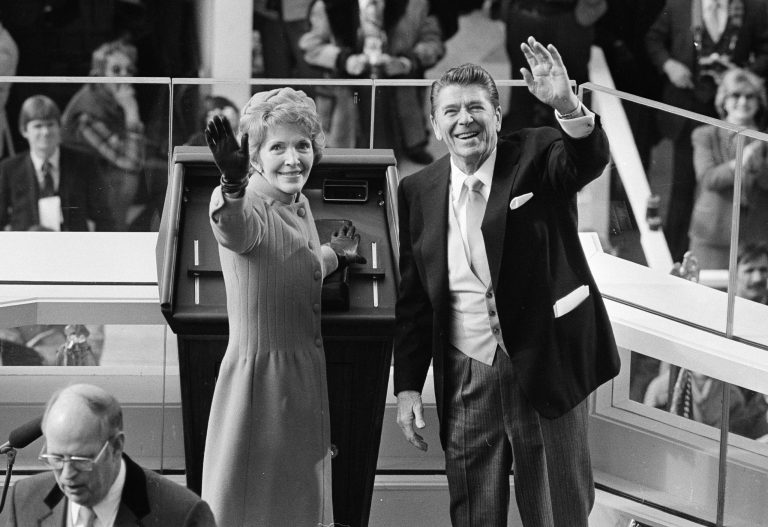 In this Jan. 20, 1981, file photo, President Ronald Reagan and first lady Nancy Reagan wave to onlookers at the Capitol building as they stand at the podium in Washington following the swearing in ceremony.