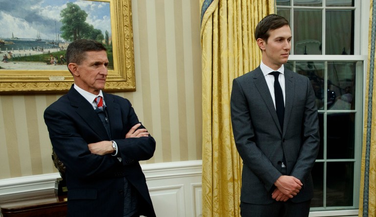 National security adviser Michael Flynn, left, and senior adviser to President Donald Trump Jared Kushner watch as Trump signs his first executive order in the Oval Office of the White House, Friday, Jan. 20, 2017, in Washington.