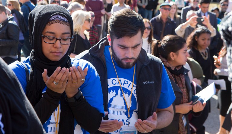 Nikita Ahmed and Zakariyy Khan pray at the Texas Capitol in Austin, Texas. 