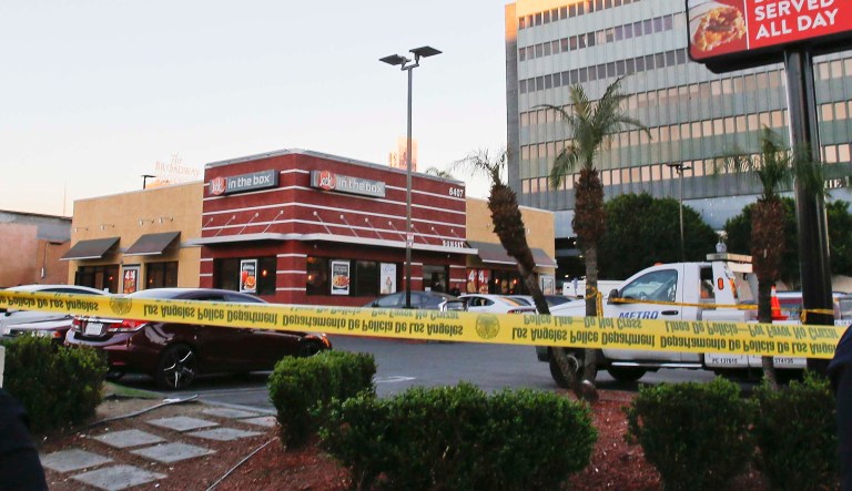 Los Angeles Police officers stand on guard, after a stabbing and police involved shooting at a Jack in the Box restaurant in Los Angeles' Hollywood district Tuesday, Jan. 31, 2017. Police say officers were answering a report of the stabbing Tuesday when they saw someone stabbing people inside the restaurant. 