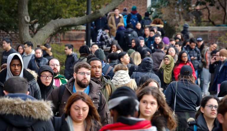 Brooklyn College students walk between classes on campus in New York.