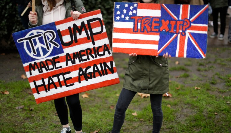 Demonstrators hold placards as they take part in a protest outside the U.S. embassy in London, against U.S. President Donald Trump's ban on travellers and immigrants from seven predominantly Muslim countries entering the U.S., Saturday, Feb. 4, 2017. 