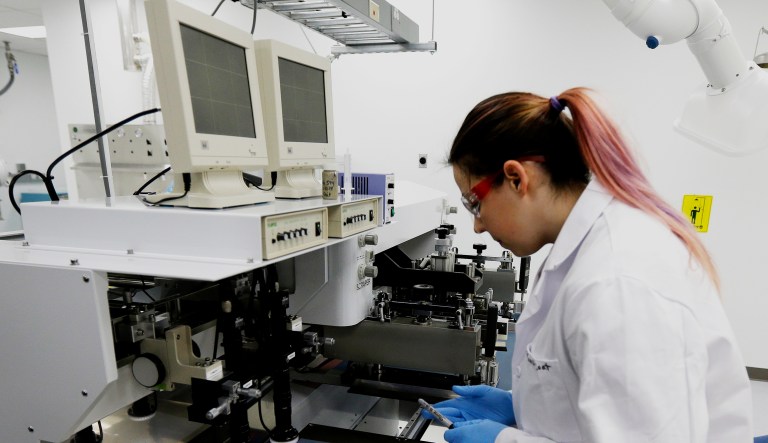 Caitlin Cramer, a PhD student in materials science engineering, demonstrates a machine that can print electrical circuits and solar cells at the newly opened Washington Clean Energy Testbeds lab housed in the University of Washington's Clean Energy Institute on Feb. 13, 2017 in Seattle.