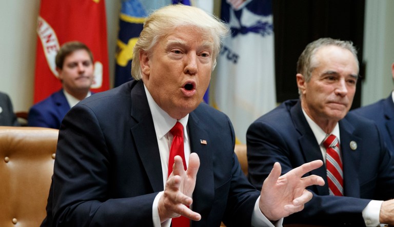 President Trump speaks during a meeting with House Republicans. Rep. Chris Collins, R-N.Y., and Rep. Duncan Hunter, R-Calif. 