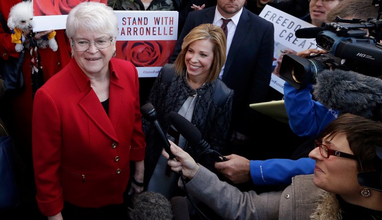 In this Nov. 15, 2016, file photo, Barronelle Stutzman, left, a Richland, Wash., florist who was fined for denying service to a gay couple in 2013, smiles as she is surrounded by supporters after a hearing before Washington's Supreme Court in Bellevue, Wash.