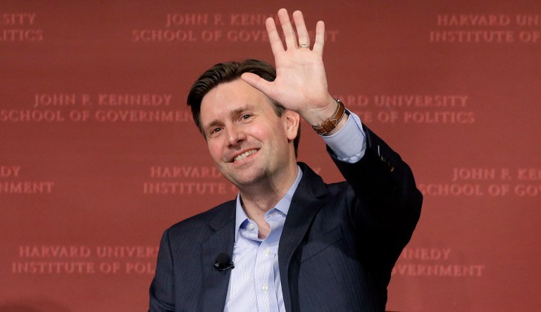 Former Obama White House press secretary Josh Earnest waves at the conclusion of a forum. 