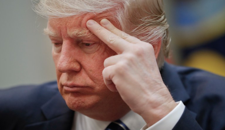 President Donald Trump listens during a meeting in the Roosevelt Room of the White House.