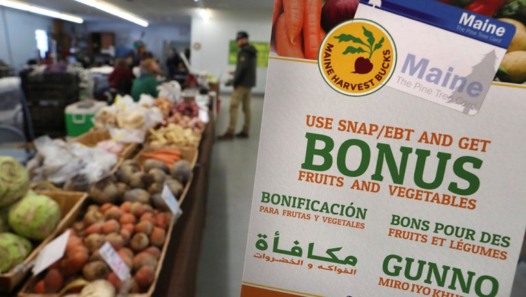 A sign advertises a program that allows food stamp recipients to use their EBT cards to shop at a farmer's market in Topsham, Maine.