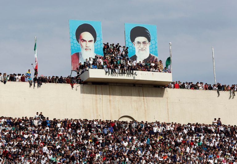 Iranian fans wait for the start of Iran and China's World Cup qualifying soccer match at the Azadi Stadium in Tehran, Iran, Tuesday, March 28, 2017. Portraits of the late Iranian revolutionary founder Ayatollah Khomeini, left, and Supreme Leader Ayatollah Ali Khamenei placed at center. Iran won the match 1-0.