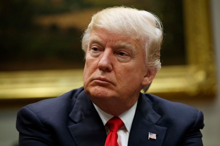 In this March 31, 2017, photo, President Donald Trump listens during a meeting with the National Association of Manufacturers in the Roosevelt Room of the White House in Washington. Slim majorities of Americans favor independent investigations into Trumpâs relationship with the Russian government and possible attempts by Russia to influence last yearâs election according to a new poll by The Associated Press-NORC Center for Public Affairs Research. 