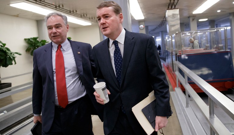 Sen. Michael Bennet, D-Colo., right, and Sen. Tim Kaine, D-Va., left, rush to the Senate chamber on Capitol Hill in Washington, Thursday, April 6, 2017, for the scheduled cloture vote to end debate on President Donald Trump's Supreme Court nominee Neil Gorsuch. 