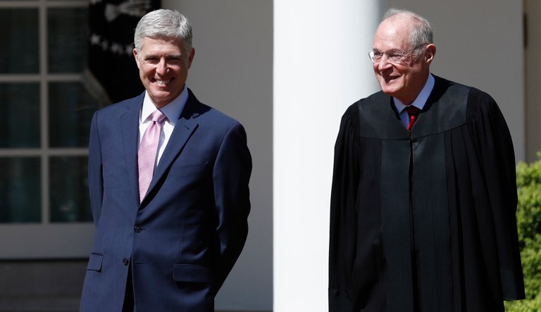 Supreme Court Justice Anthony Kennedy, right, and Justice Neil Gorsuch, center, participate in a public swearing-in ceremony for Gorsuch in the Rose Garden of the White House White House in Washington, Monday, April 10, 2017. 
