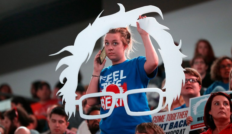 Carly Hein, of Omaha, Neb., talks on her cell phone as she waits for Sen. Bernie Sanders, I-Vt., to arrive at a rally for Omaha Democratic mayoral candidate Heath Mello, Thursday, April 20, 2017, in Omaha, Neb. 