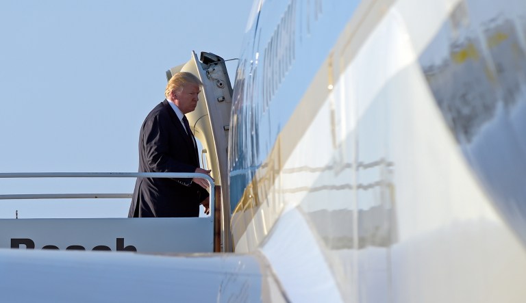 President Donald Trump walks up the steps the steps of Air Force One at Palm Beach International Airport in West Palm Beach, Fla.