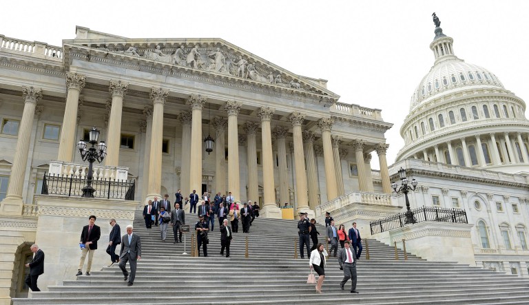 House members walk down the steps of the Capitol in Washington.