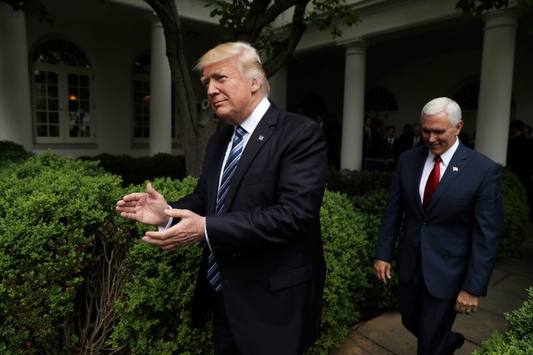 President Donald Trump claps as he arrives in the Rose Garden of the White House, Thursday, May 4, 2017, in Washington, followed by Vice President Mike Pence after the House pushed through a health care bill.  