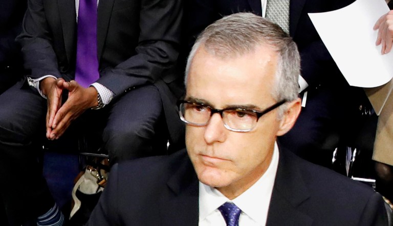 Photographers surround then-acting FBI Director Andrew McCabe as he takes his seat.