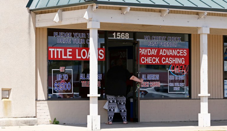 A woman enters an All American Check Cashing location in Brandon, Miss., Friday, May 12, 2017. The Mississippi Department of Banking and Consumer Finance issued an order Thursday, May 11, revoking 75 licenses held by All American, one of the state's largest payday lenders, ordering an immediate stop to new loans. The company must pay fines of $1.58 million and refunds to at least 700 customers. 