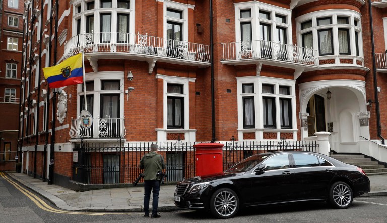 A photographer stands outside of the Ecuadorian embassy in London.