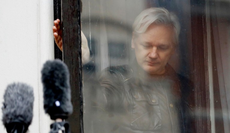 Julian Assange leaves after greeting supporters outside the Ecuadorian embassy in London.
