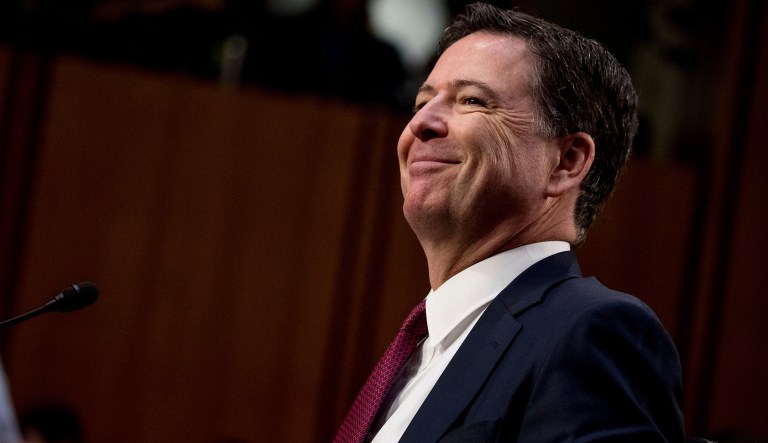 Former FBI Director James Comey smiles during a Senate Intelligence Committee hearing. (AP Photo/Andrew Harnik)
