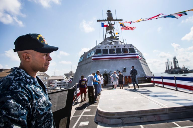 BM1 (SW) Marco Negron stands on the foredeck of the U.S.S. Gabrielle Giffords LCS-10 as he gives a tour following the littoral combat ship's commissioning ceremony on Saturday, June 10, 2017, in Galveston, Texas. (Brett Coomer/Houston Chronicle via AP)