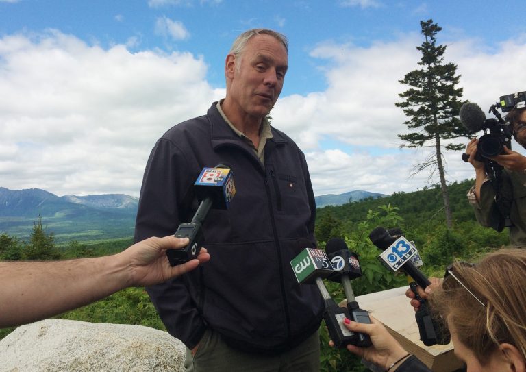 Interior Secretary Ryan Zinke talks with reporters with part of Mount Katahdin in the background at the Katahdin Woods And Waters National Monument near Staceyville, Maine, Wednesday, June 14, 2017. Zinke praised the beauty of the national monument Wednesday and said he's "comfortable" with the National Park Service property remaining in public hands.