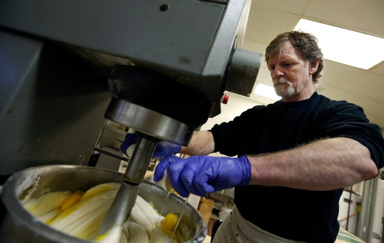 Masterpiece Cakeshop owner Jack Phillips cracks eggs into a cake batter mixer inside his store in Lakewood, Colo. The Supreme Court is taking on a new clash between gay rights and religion in a case about a wedding cake for a same-sex couple in Colorado. 