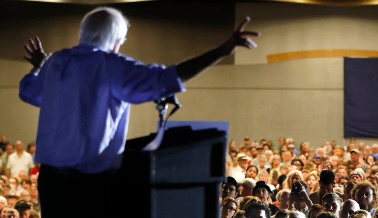 People listen as Sen. Bernie Sanders, I-Vt., speaks during a rally.