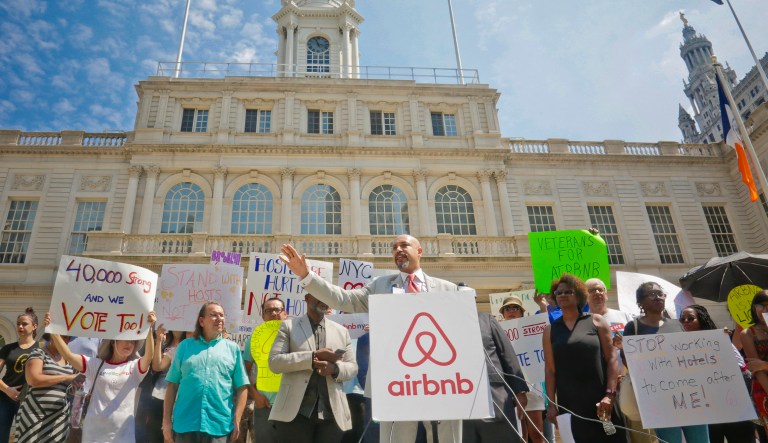 Rev. Kirsten Foy, center, National Action Network regional director, leads a rally of Airbnb hosts at City Hall, Wednesday July 19, 2017, in New York. Airbnb hosts in the city are concerned about reports that the Mayor's Office of Special Enforcement is using information from the hotel industry's spying campaign to unfairly target them.
